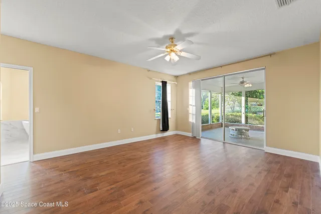 a bathroom with a granite countertop double vanity sink a large mirror a bathtub and next to a window