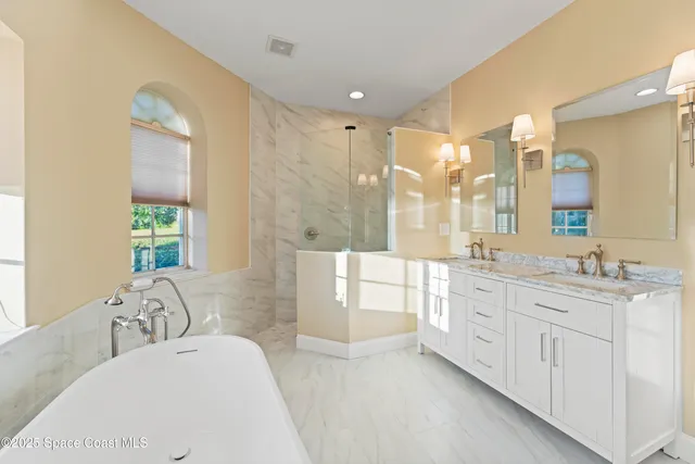 a view of an empty room with a chandelier fan