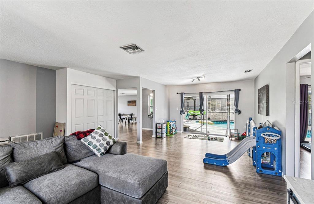 7112 Vista Way New Port Richey, FL 34653 - Photo 11 of 54 a living room with furniture and wooden floor