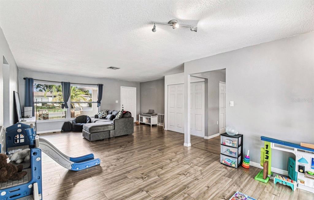 7112 Vista Way New Port Richey, FL 34653 - Photo 14 of 54 a living room with furniture and a wooden floor