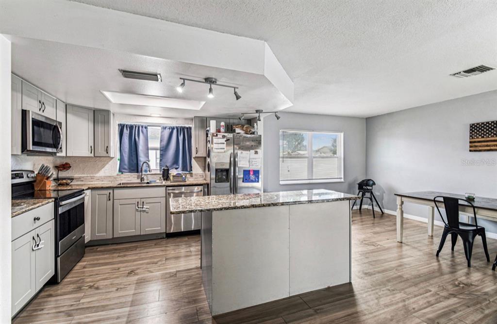 7112 Vista Way New Port Richey, FL 34653 - Photo 17 of 54 a large kitchen with lots of counter space a sink and appliances
