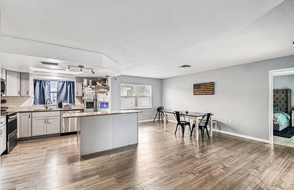 7112 Vista Way New Port Richey, FL 34653 - Photo 18 of 54 a living room with stainless steel appliances furniture and wooden floor