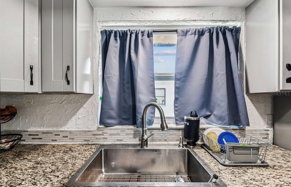 7112 Vista Way New Port Richey, FL 34653 - Photo 24 of 54 a kitchen with sink and a stove top oven