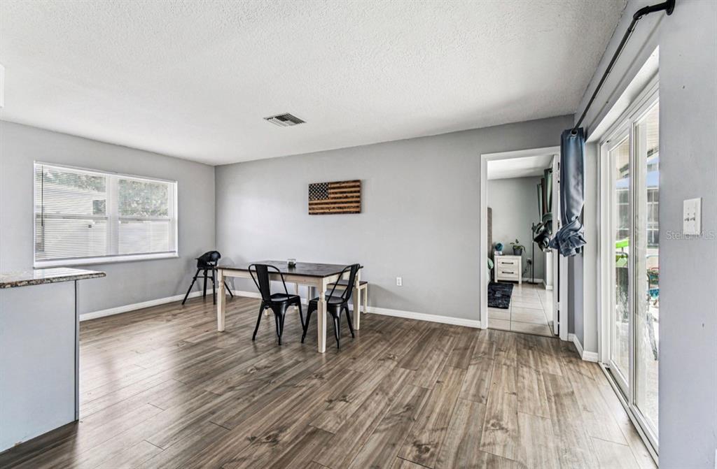 7112 Vista Way New Port Richey, FL 34653 - Photo 26 of 54 a view of a room with wooden floor lounge chair and windows
