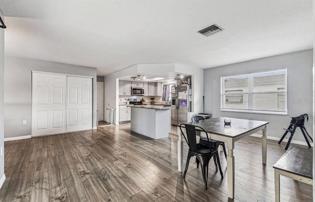 7112 Vista Way New Port Richey, FL 34653 - Photo 27 of 54 a view of a dining room with furniture and wooden floor