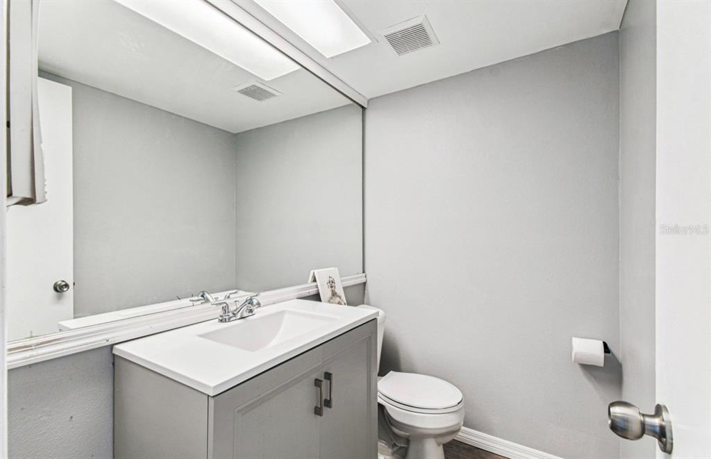 7112 Vista Way New Port Richey, FL 34653 - Photo 31 of 54 a bathroom with a sink toilet and mirror