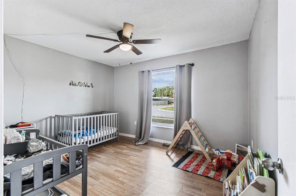 7112 Vista Way New Port Richey, FL 34653 - Photo 37 of 54 a bedroom with furniture and a window