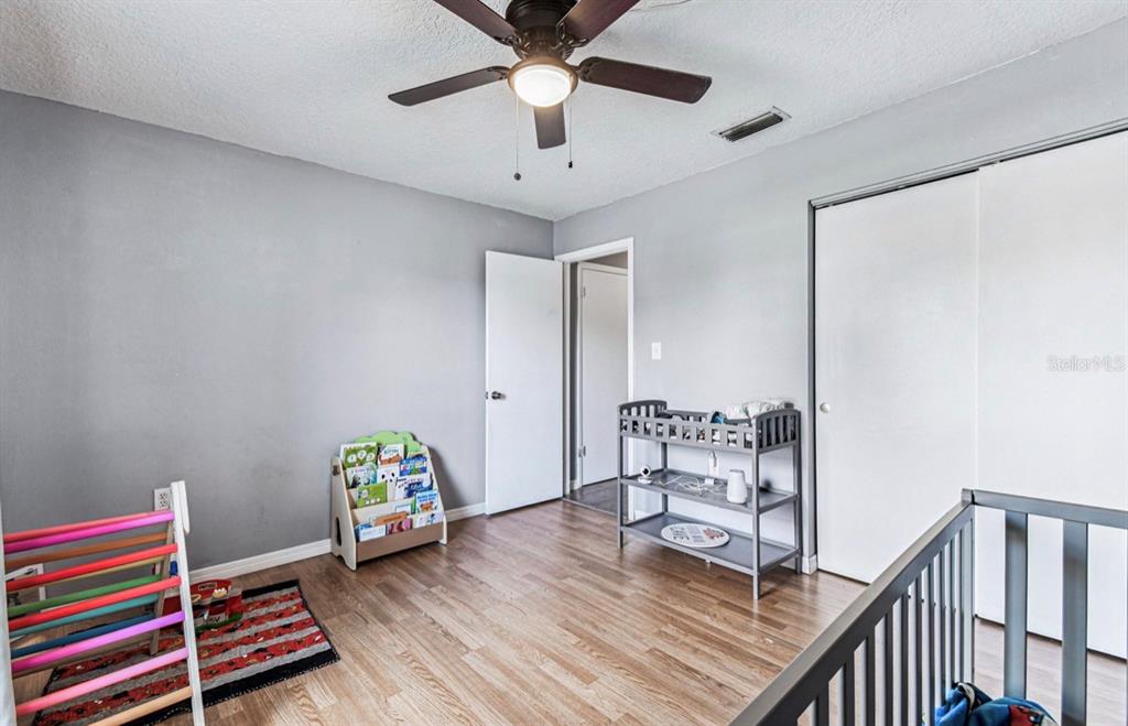 7112 Vista Way New Port Richey, FL 34653 - Photo 38 of 54 a bedroom with furniture and a wooden floor