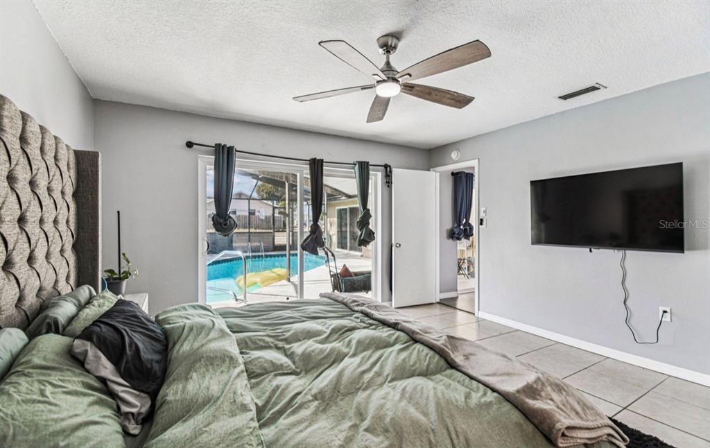 7112 Vista Way New Port Richey, FL 34653 - Photo 41 of 54 a bedroom with a bed and a flat screen tv