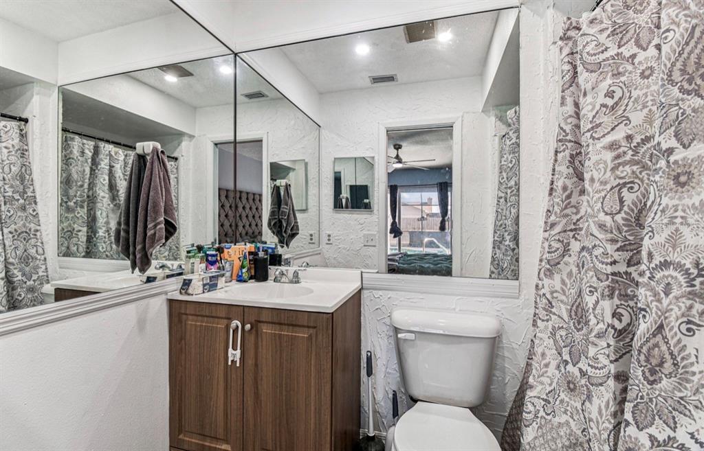 7112 Vista Way New Port Richey, FL 34653 - Photo 42 of 54 a bathroom with a toilet sink and mirror