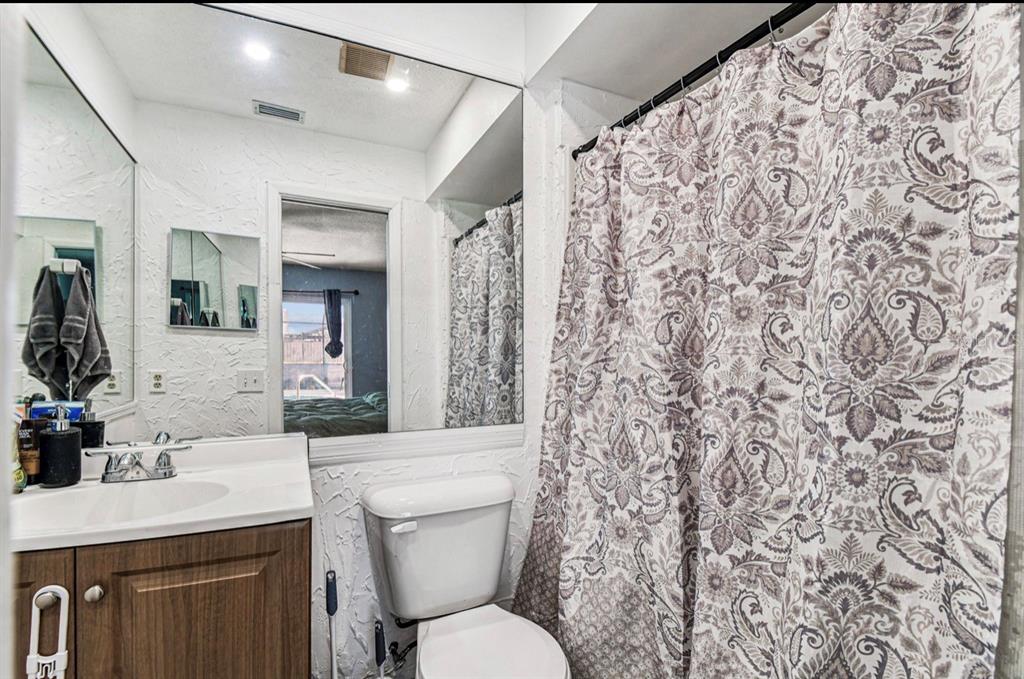 7112 Vista Way New Port Richey, FL 34653 - Photo 43 of 54 a bathroom with a toilet sink and mirror