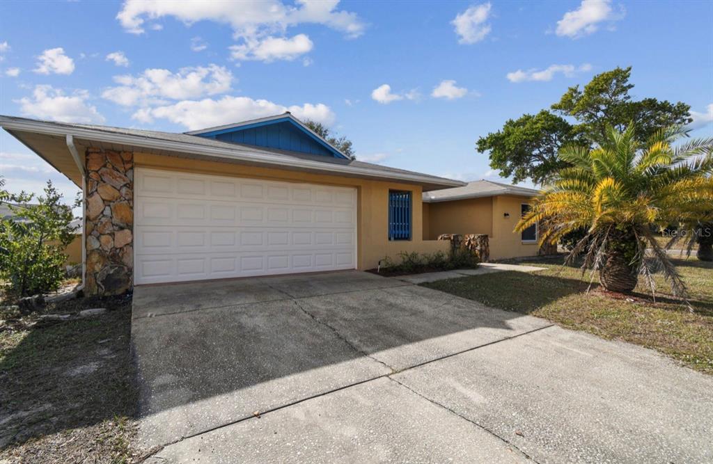 7112 Vista Way New Port Richey, FL 34653 - Photo 5 of 54 a view of a house with a yard and garage