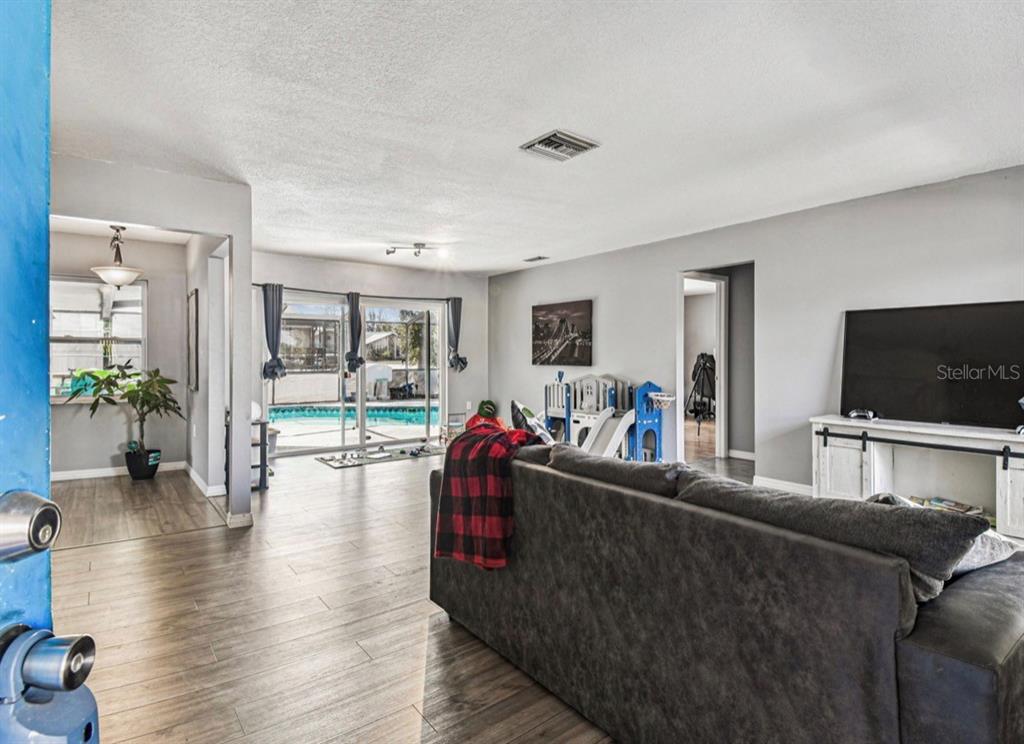 7112 Vista Way New Port Richey, FL 34653 - Photo 6 of 54 a living room with furniture and a flat screen tv