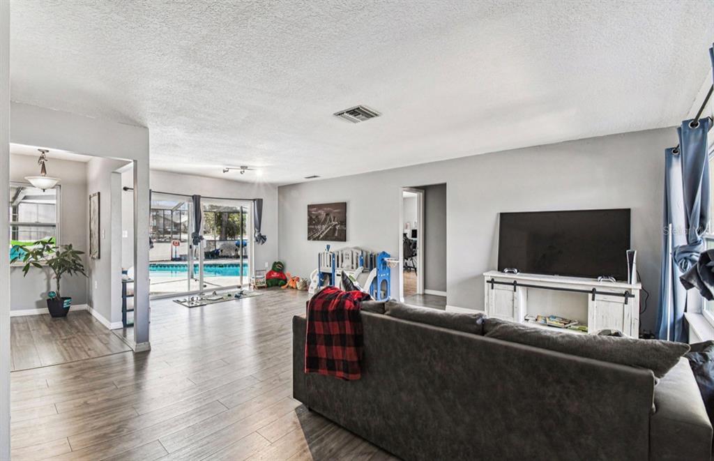 7112 Vista Way New Port Richey, FL 34653 - Photo 7 of 54 a living room with furniture and a flat screen tv