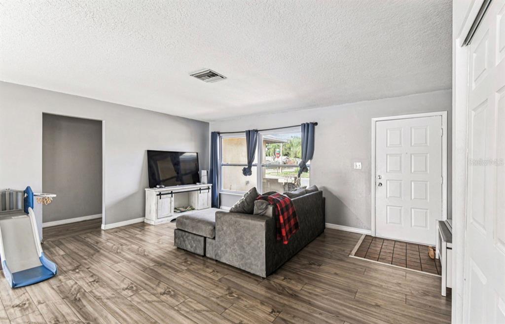 7112 Vista Way New Port Richey, FL 34653 - Photo 8 of 54 a living room with furniture and a flat screen tv