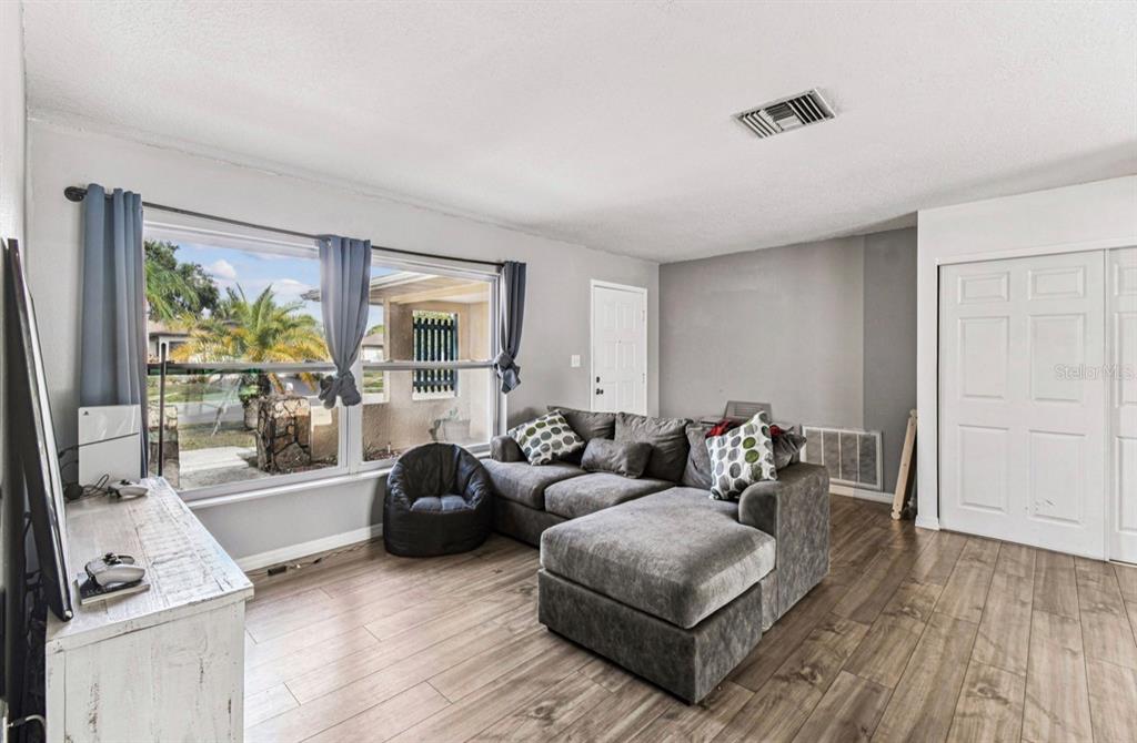 7112 Vista Way New Port Richey, FL 34653 - Photo 10 of 54 a living room with furniture and a large window