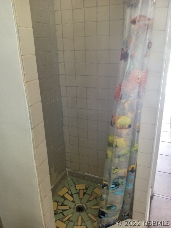 703 South Ridgewood Avenue, Unit 4 Edgewater, FL 32132 - Photo 4 of 4 a bathroom with a shower