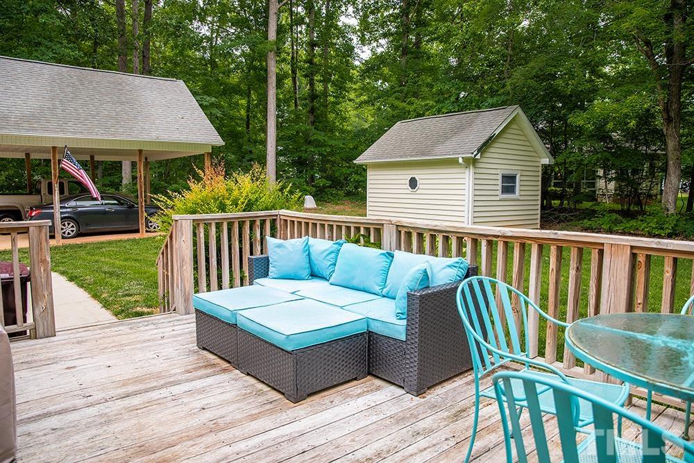 307 Oaks Lane Road Timberlake, NC 27583 - Photo 34 of 43 a view of a wooden chairs and table in the deck
