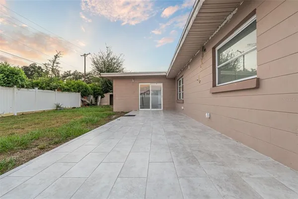 a view of a house with a backyard