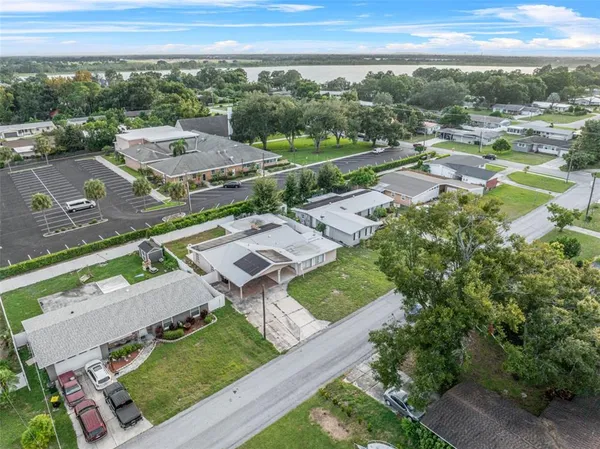 an aerial view of a city with lots of residential buildings lake and ocean view