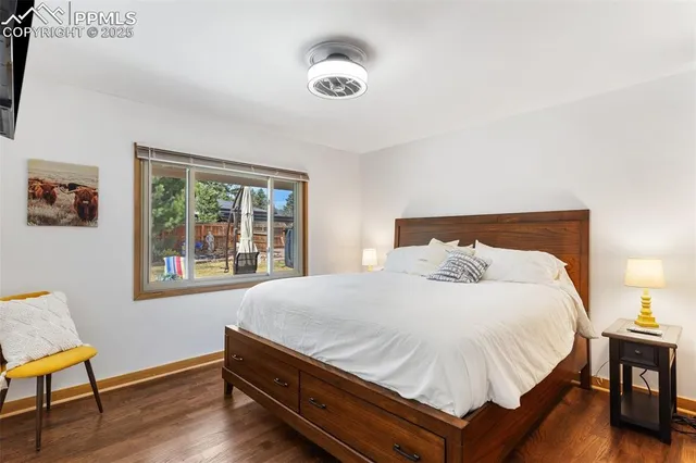 a large bed sitting in a bedroom next to a window