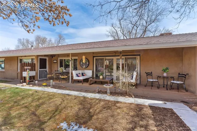 a front view of house with yard outdoor seating and barbeque oven