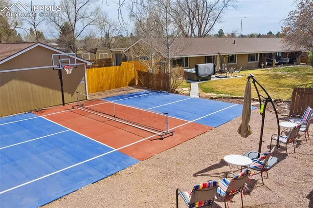 a blue swimming pool with outdoor seating and yard