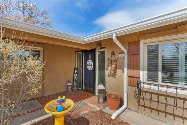 a front view of a house with outdoor seating