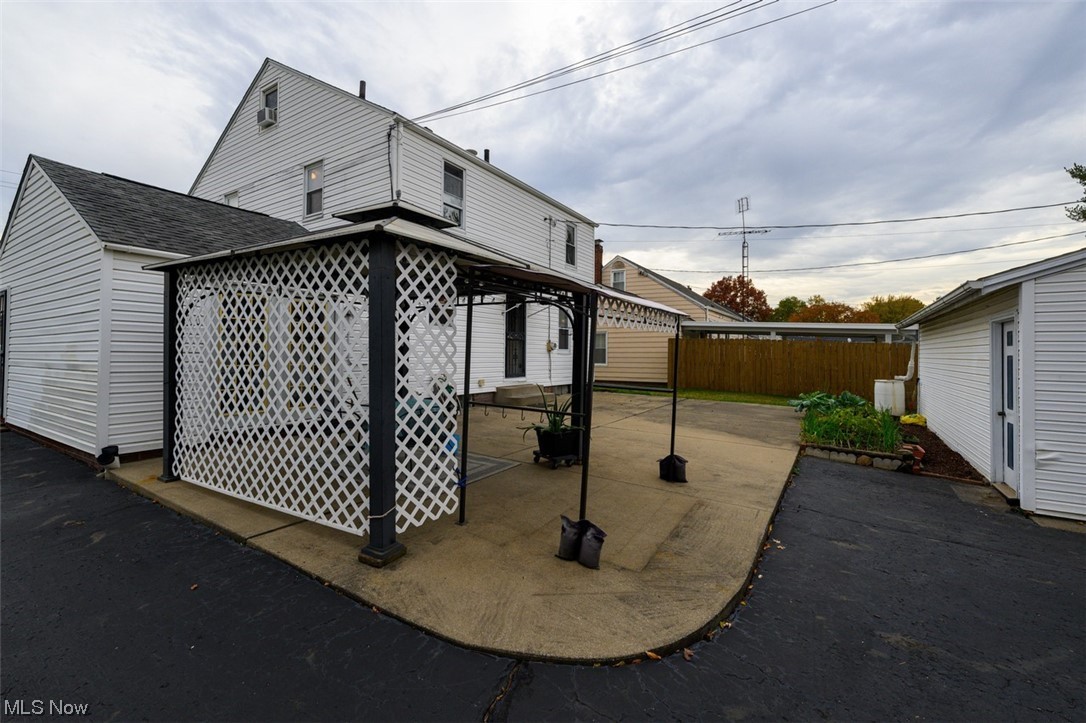 241 Everhard Road Southwest North Canton, OH 44709 - Photo 19 of 21 Back of house featuring a patio area