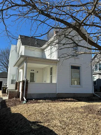 an empty room with a window and ceiling fan