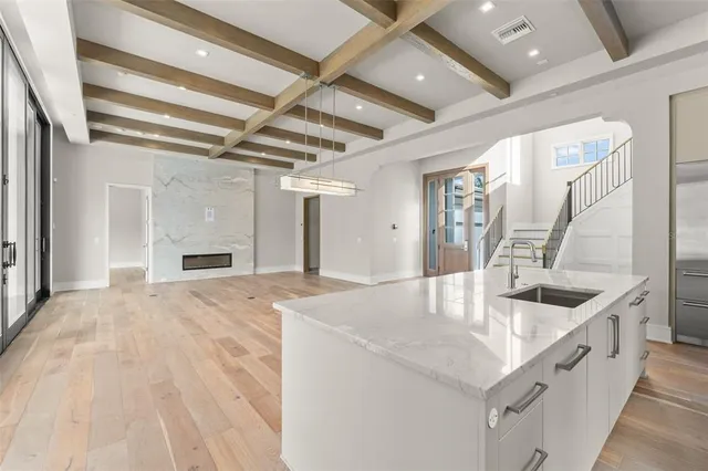 a kitchen with sink refrigerator and window