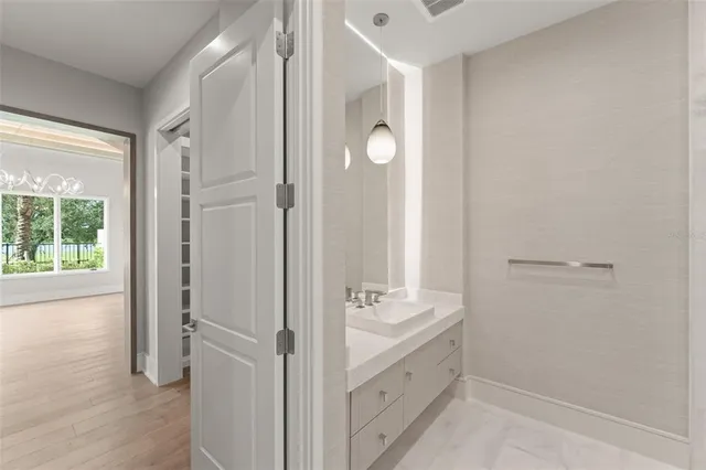 a bathroom with a double vanity sink and mirror with shower