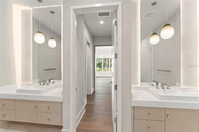a bathroom with a sink vanity and a mirror