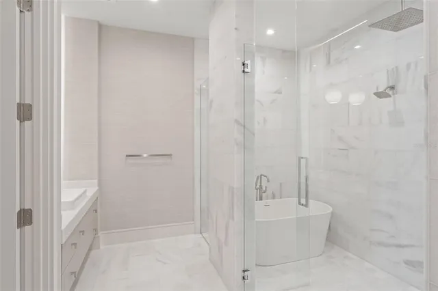 a bathroom with a bathtub and shower