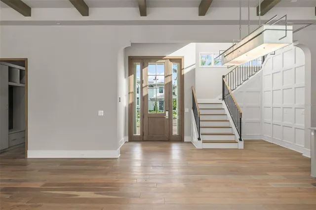 a view of entryway with stairs and wooden floor