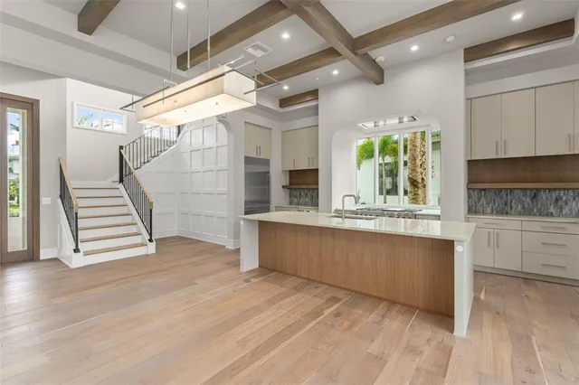 a view of a kitchen with wooden floors and a window