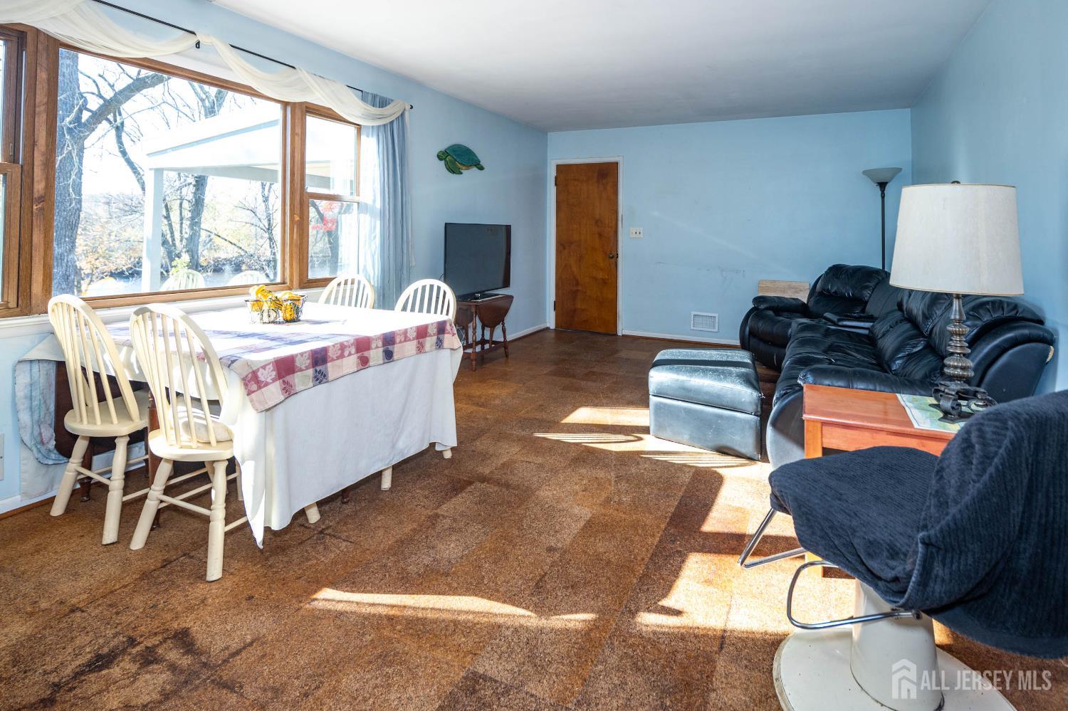 900 River Road Piscataway, NJ 08854 - Photo 13 of 37 a living room with furniture a rug and a floor to ceiling window