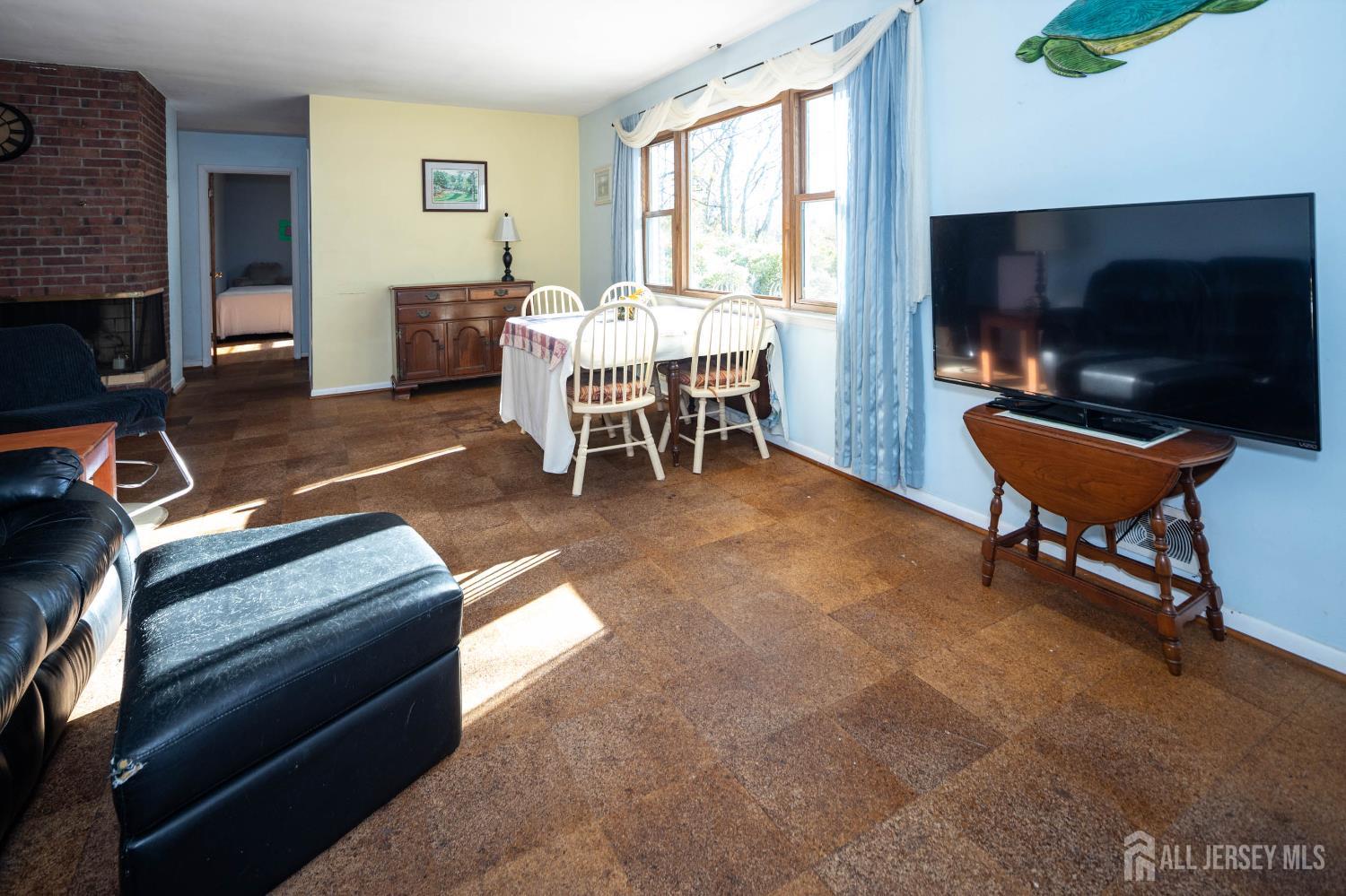 900 River Road Piscataway, NJ 08854 - Photo 15 of 37 a living room with furniture a flat screen tv and a fireplace