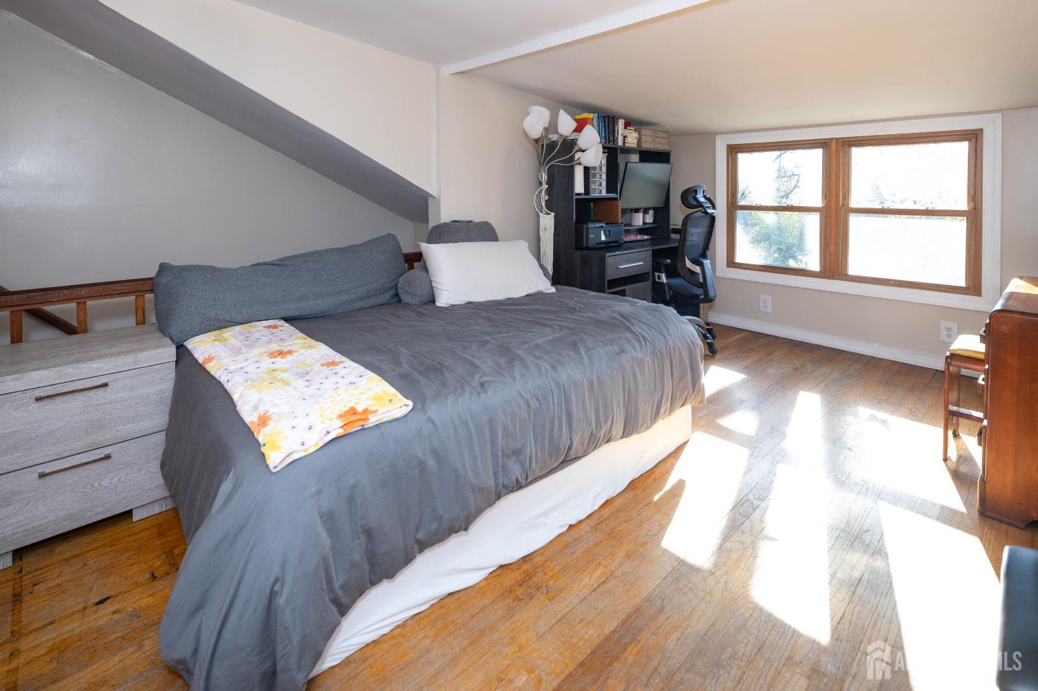 900 River Road Piscataway, NJ 08854 - Photo 24 of 37 a bedroom with a bed and wooden floor