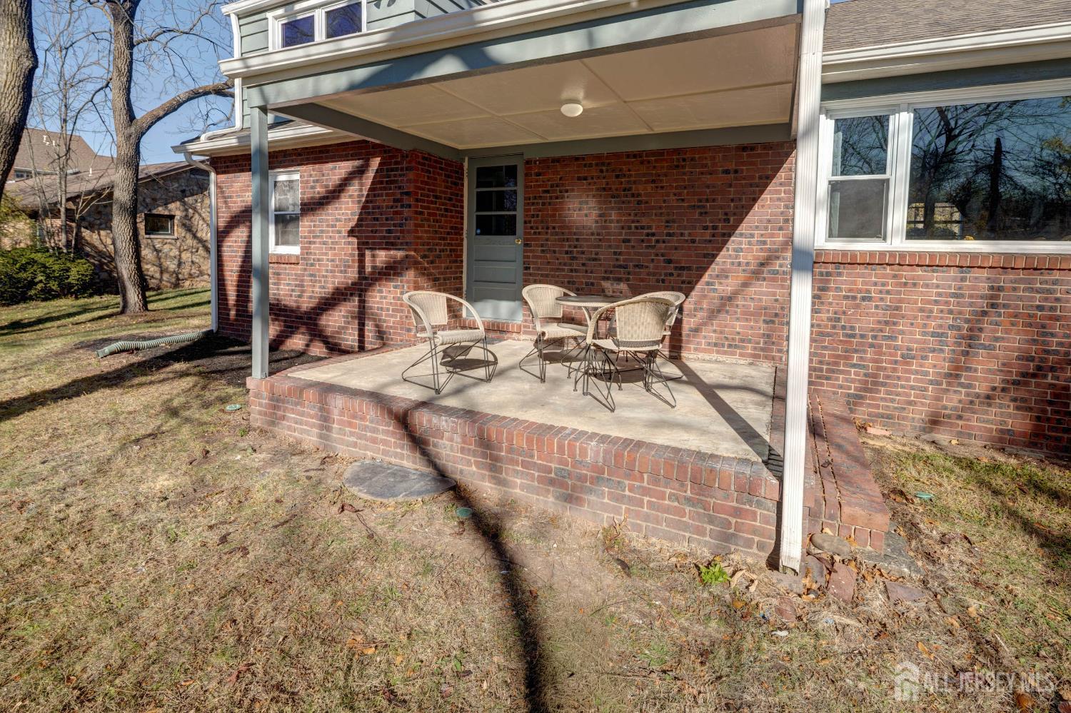 900 River Road Piscataway, NJ 08854 - Photo 31 of 37 a view of a patio with table and chairs with wooden floor and fence