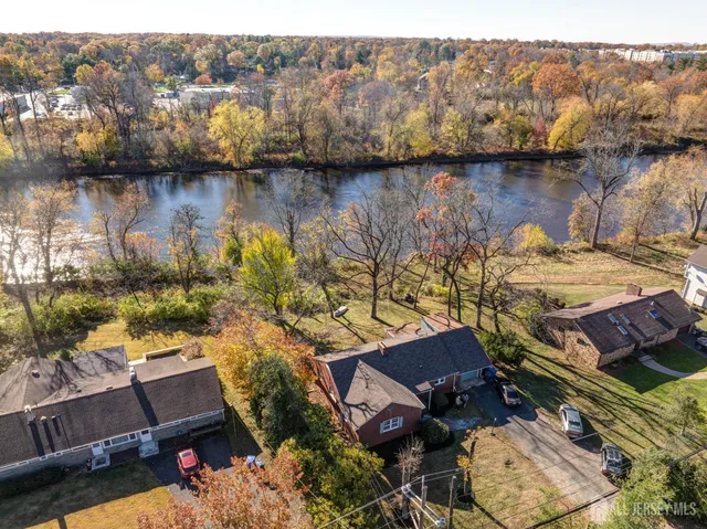 an aerial view of a house with a lake view