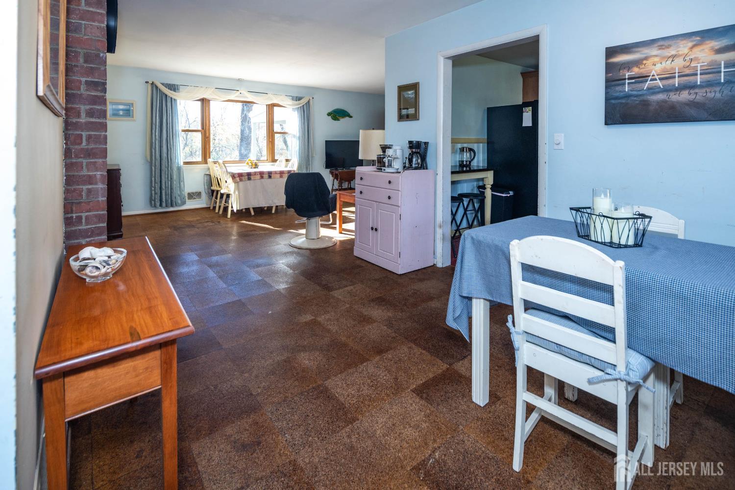 900 River Road Piscataway, NJ 08854 - Photo 10 of 37 a living room with furniture a flat screen tv and a refrigerator