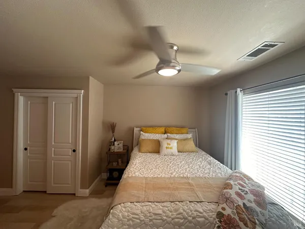 a bedroom with a bed and a chandelier