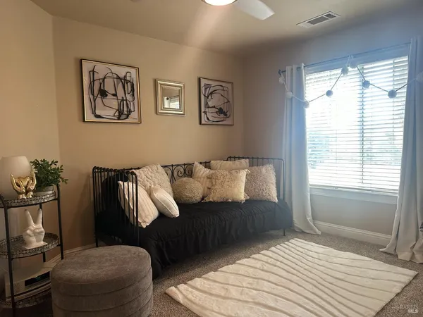 a bedroom with a bed and a couch
