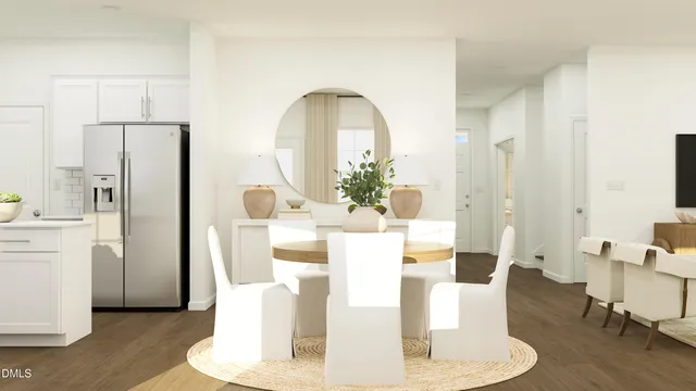 a dining room with furniture a kitchen a refrigerator and wooden floor