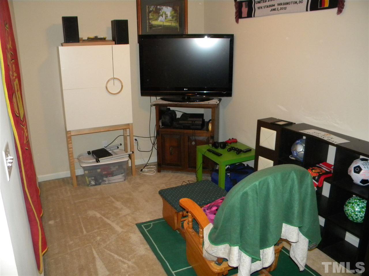 4608 Altha Street Raleigh, NC 27606 - Photo 11 of 12 a living room with furniture and a flat screen tv