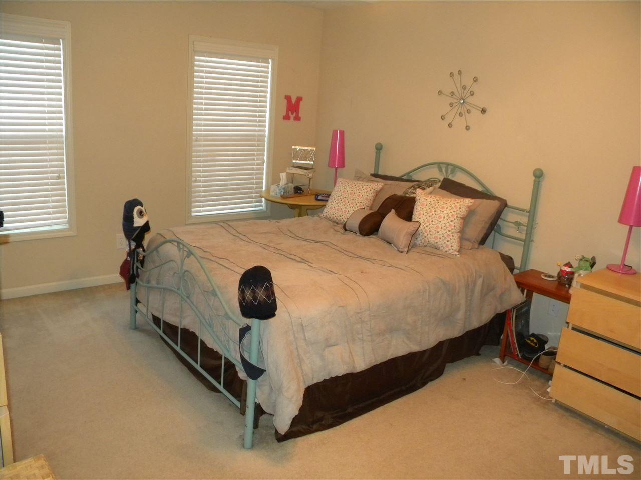 4608 Altha Street Raleigh, NC 27606 - Photo 8 of 12 a bed sitting in a bedroom next to a window