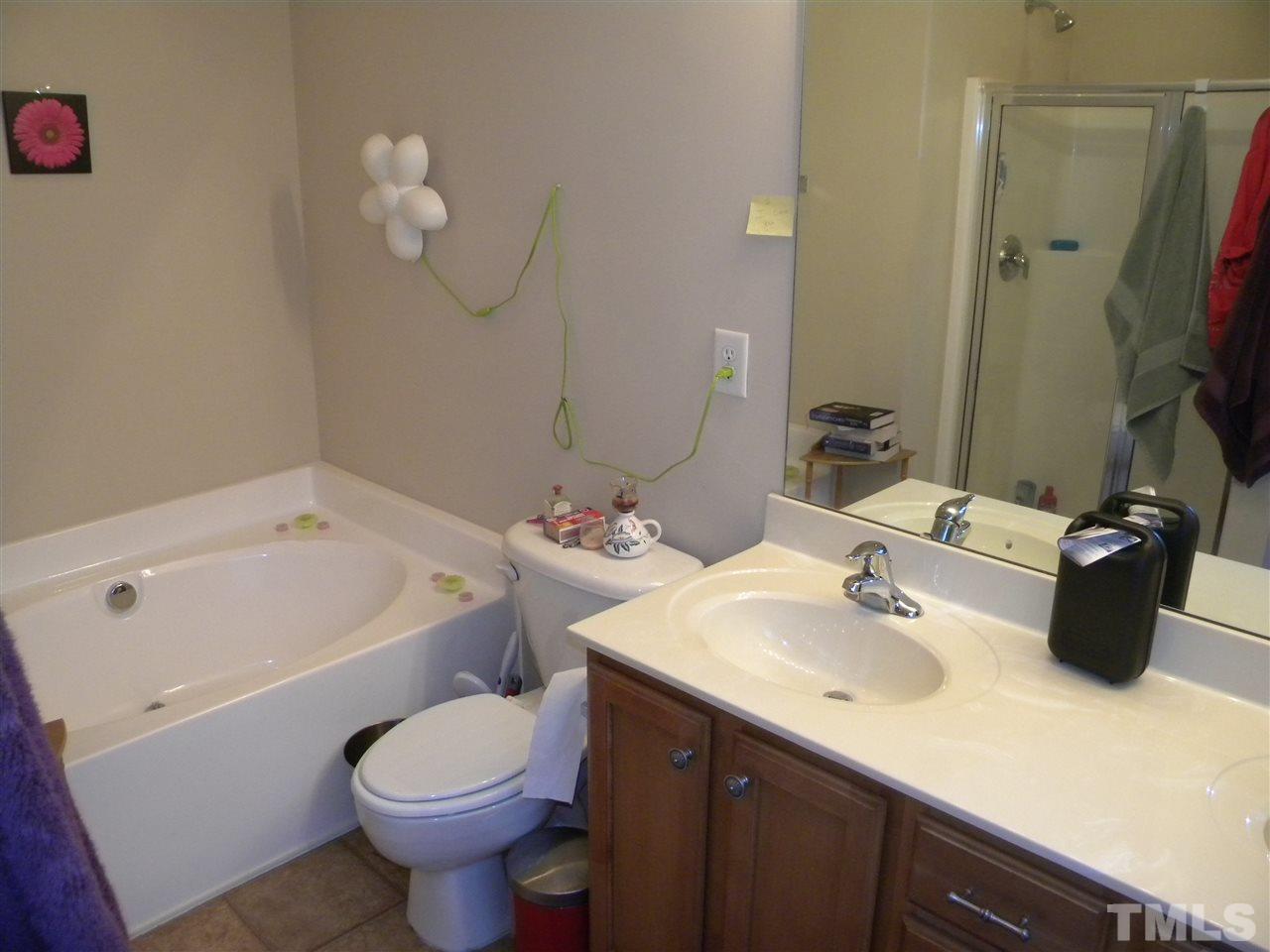 4608 Altha Street Raleigh, NC 27606 - Photo 9 of 12 a bathroom with a sink and a mirror