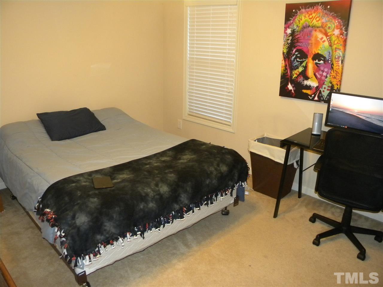 4608 Altha Street Raleigh, NC 27606 - Photo 10 of 12 a bedroom with a bed and a window