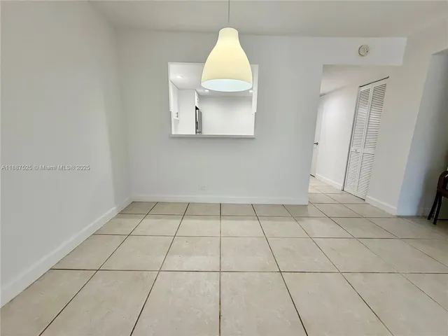 an empty room with a sink and a mirror